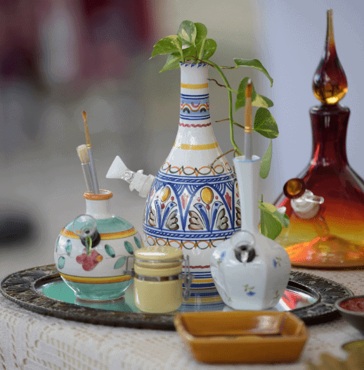 fancy glass and ceramic bongs on a table.