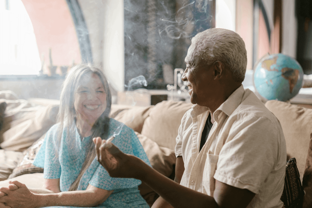 Two older adults in their sixties using cannabis together.