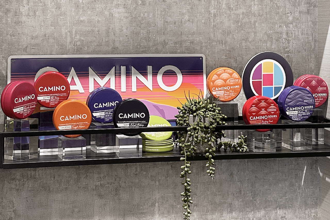Brand display of various Camino Gummies packages.