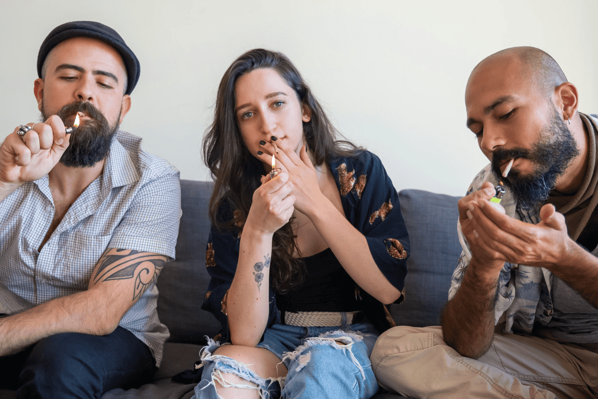 A group of men and women smoking cannabis.