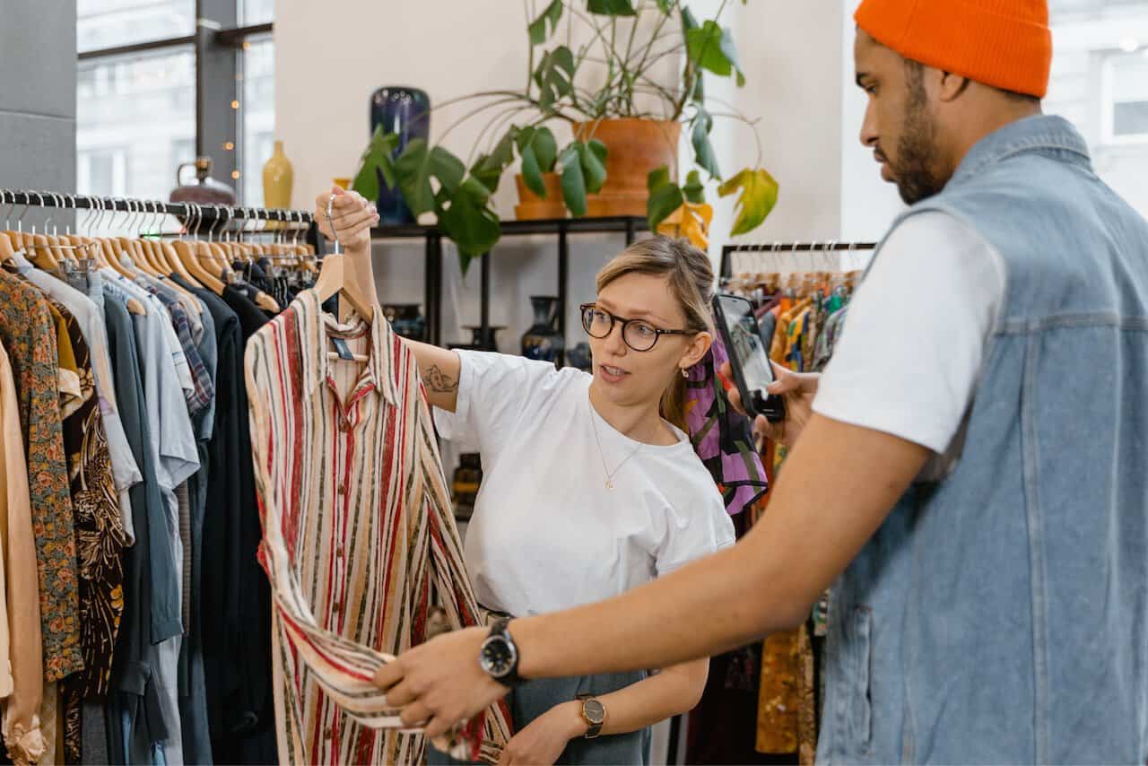 Woman and man shopping at a vintage clothing store.